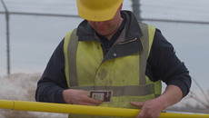 Lineman in the field pulls out a Polywater hot stick wipe while holding his hot stick 230p